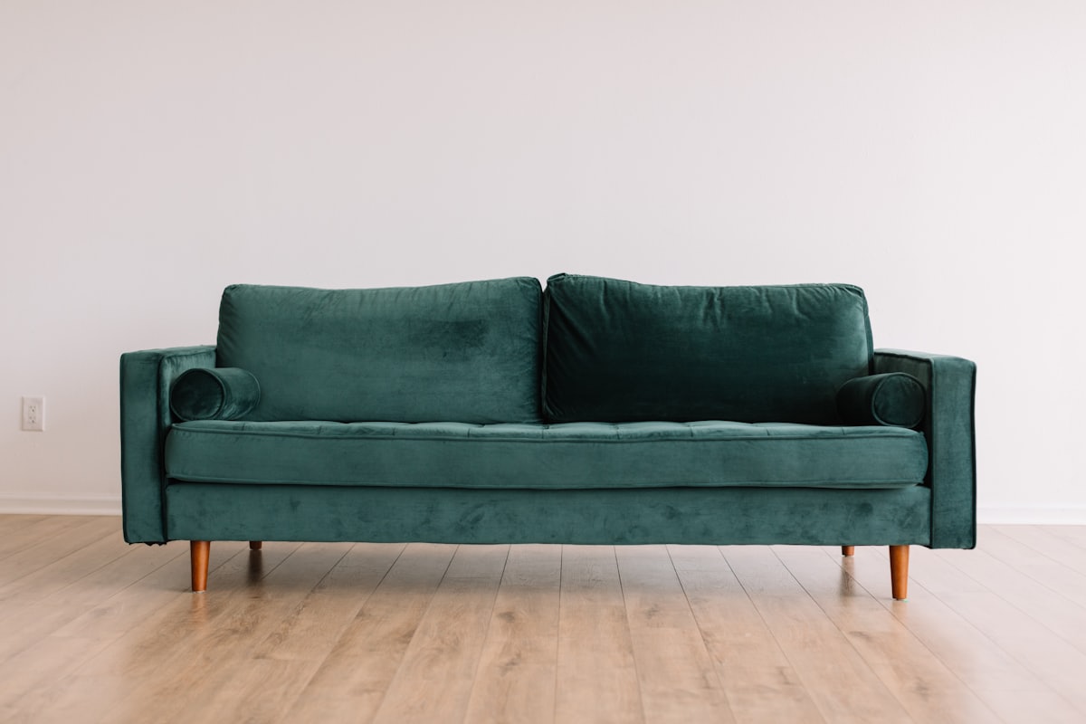 Wooden coffee table and comfortable sofa styled in a warm modern living room